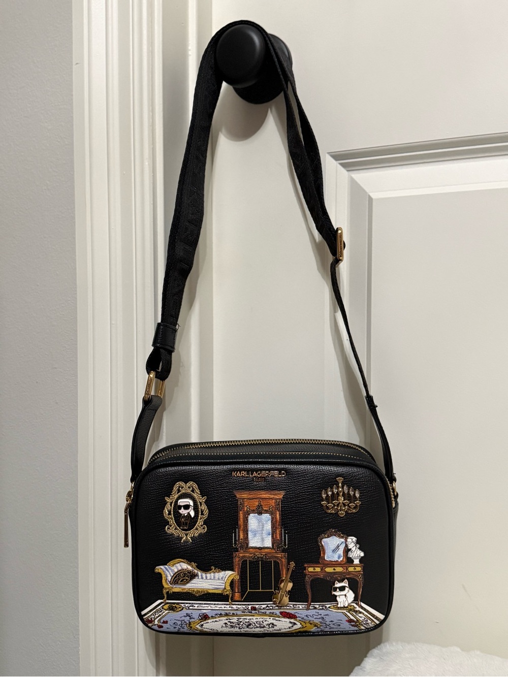 Karl Lagerfeld Black Crossbody Bag with Gold Accents and Decorative Room Print